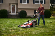 Photo of Craftsman lawn mower CMCMWSP220P2 in use on grass, front side view, outdoor residential setting.