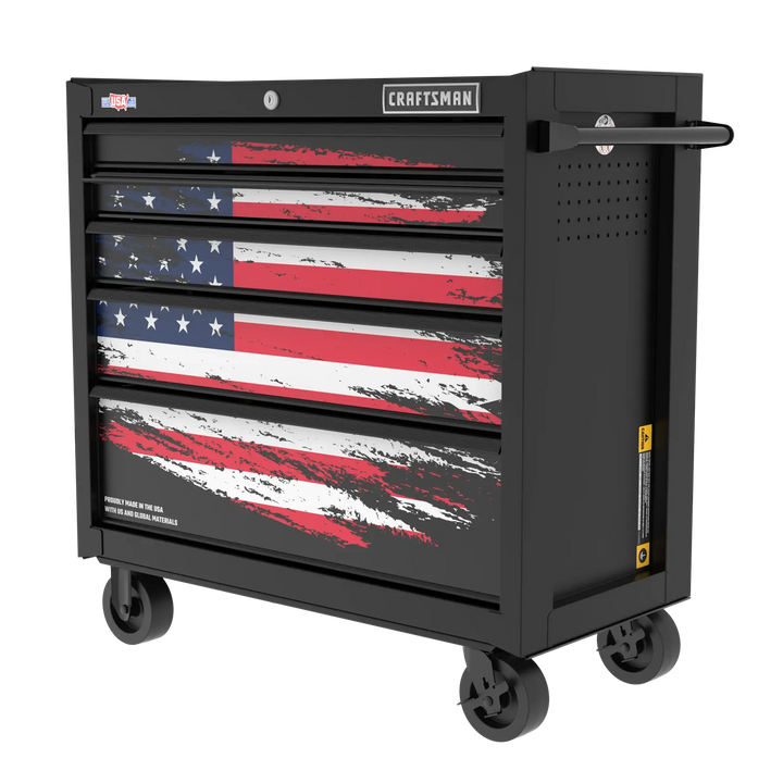 A black rolling tool chest with four drawers, featuring a stylized American flag design on the front. The chest has wheels for mobility and a handle on the side. The brand 'CRAFTSMAN' is visible at the top.