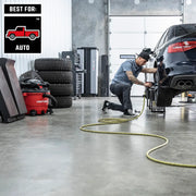 Photo of Craftsman CMXZVBE38802 wet/dry vacuum in a garage near stacked tires and a person working on a car.